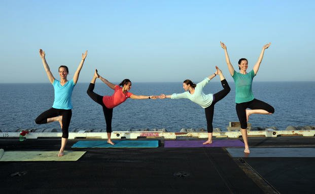 women doing yoga onboard ship