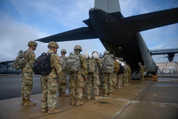 Army soldiers board a C130 Hercules and prepare for departure at McAllen, Texas