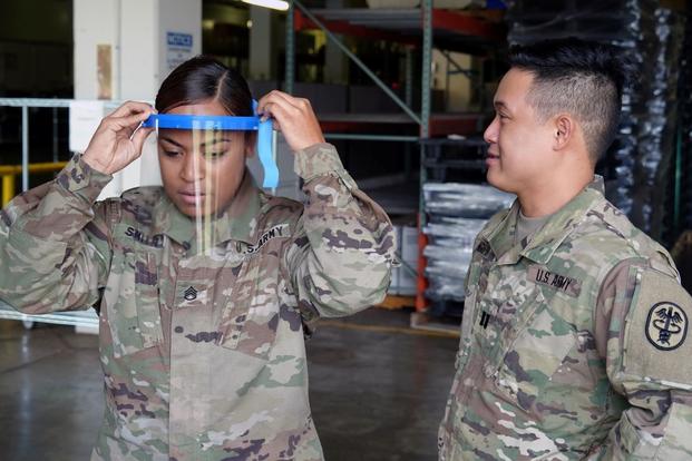 U.S. Army Staff Sgt. Jacklyn Smith adjusts her face shield at Tripler Army Medical Center medical warehouse.