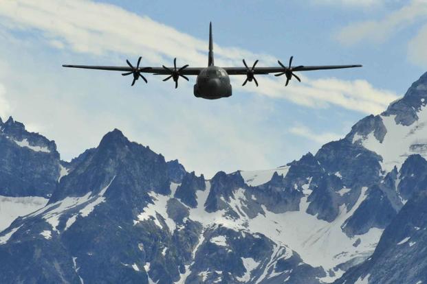 A C-130J assigned to the 41st Airlift Squadron at Little Rock Air Force Base performs low-level training through the Alaskan mountains.
