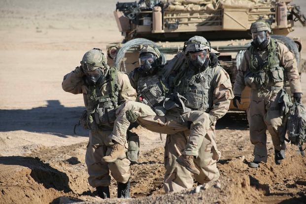 U.S. Soldiers carry a wounded soldier to a medical evacuation point, during Decisive Action Rotation 17-04 at the National Training Center.