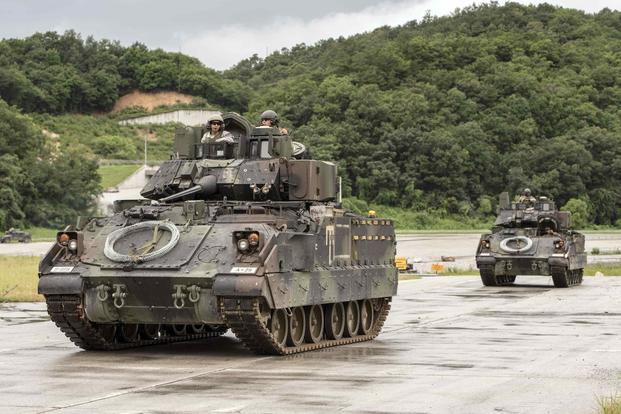 Bradley Fighting Vehicles return after conducting breaching operations.