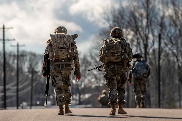 Warrant officer candidates  participate in a 10-kilometer ruck march.