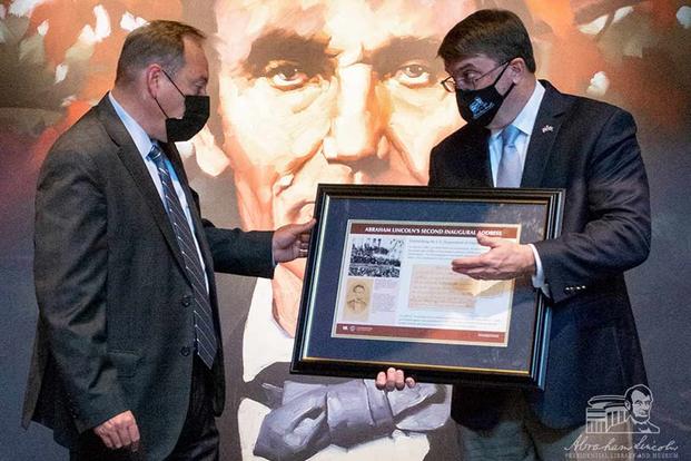 Robert Wilkie presents a framed keepsake of Lincoln's 2nd Inaugural Address.