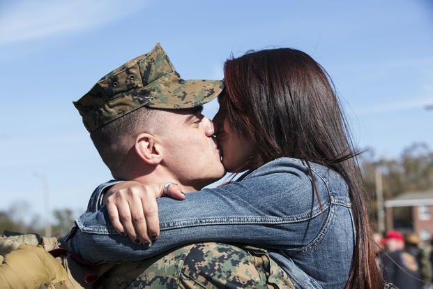 couple kissing after deployment