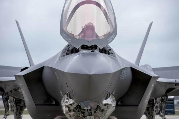 An F-35 Lightning II pilot prepares to exit the cockpit.