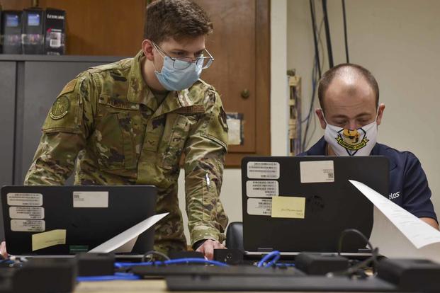 Two airmen explore ways to remotely add computers at Seymour Johnson Air Force Base.