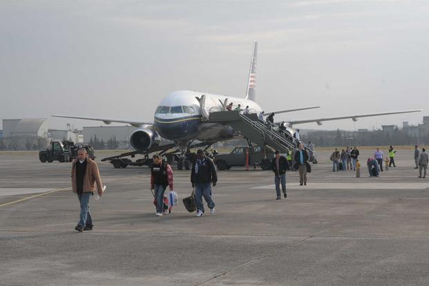 Passengers arrive at Yokota Air Base, Japan via the Patriot Express.