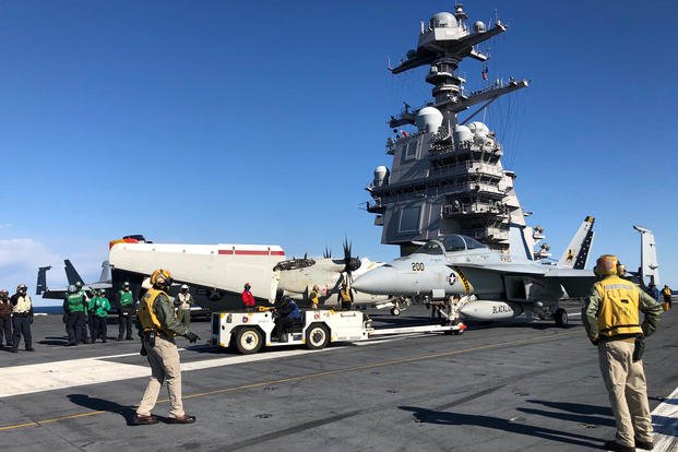 An F/A-18 Super Hornet is towed into position on the flight deck of the carrier Gerald R. Ford Nov. 17, 2020 (Hope Hodge Seck/Staff)