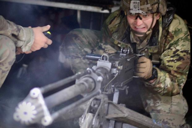 A soldier fires blank rounds from an M2 .50 caliber machine gun during training at Joint Base Lewis-McChord, Wash.