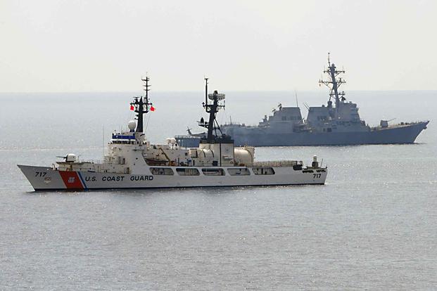 The Arleigh Burke-class guided-missile destroyer Chung-Hoon and Coast Guard cutter Mellon pass each other