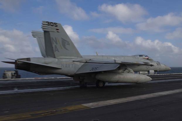 An F/A-18E Super Hornet launches off of the aircraft carrier USS Nimitz.