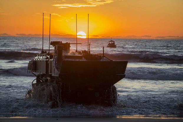 U.S. Marines drive a new Amphibious Combat Vehicle ashore.
