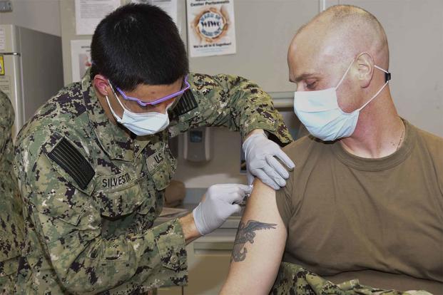 Hospitalman administers COVID-19 vaccine at Naval Medical Center Portsmouth.