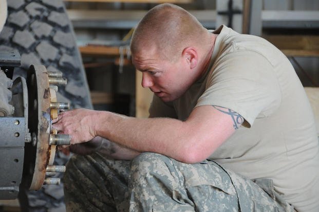 Specialist performs maintenance on a vehicle
