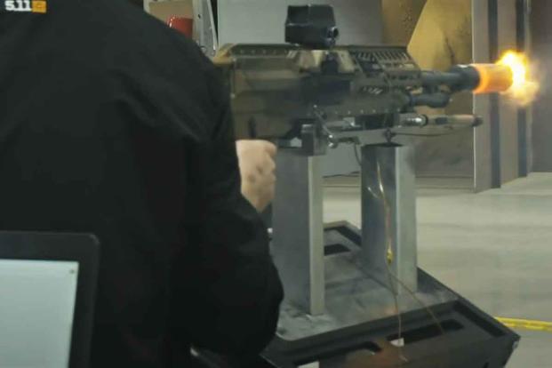 Sig Sauer officials test fire the auto rifle prototype of their NGSW prototype.
