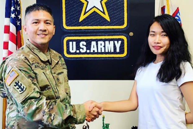 U.S. Army New York City Recruiting Battalion recruiter shakes hands with new recruit