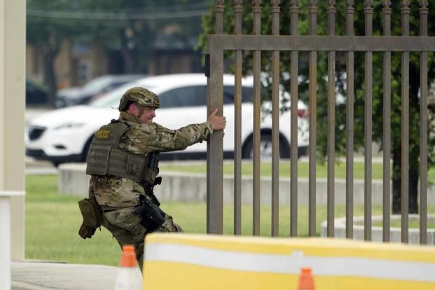 A military policeman closes a gate at Joint Base San Antonio-Lackland.
