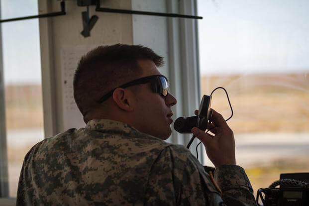 Soldier communicates with pilots during training.