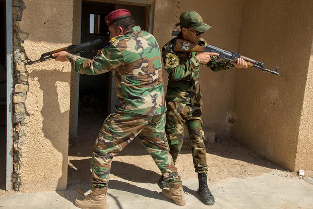 Iraqi Security Forces prepare to breach rooms.