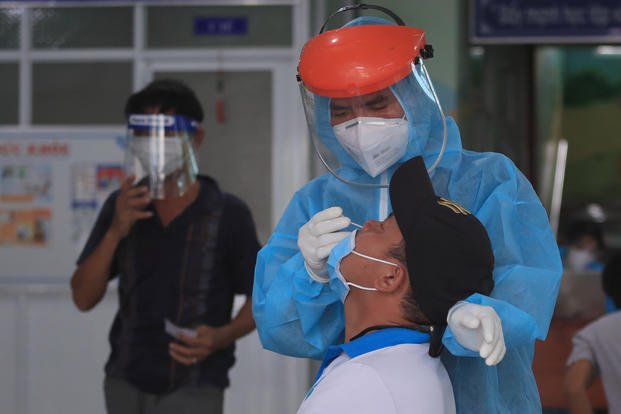 A medical worker takes swab sample from a man in Vung Tau city, Vietnam.