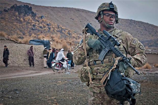 Soldier surveys a village near Forward Operating Base Salerno in Afghanistan, 