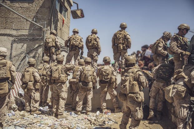 Marines assist with security at Afghan airport.