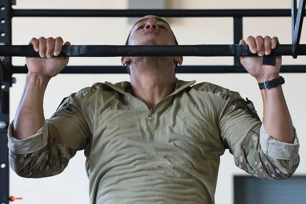 Airman works on pull-ups at Fort Riley.