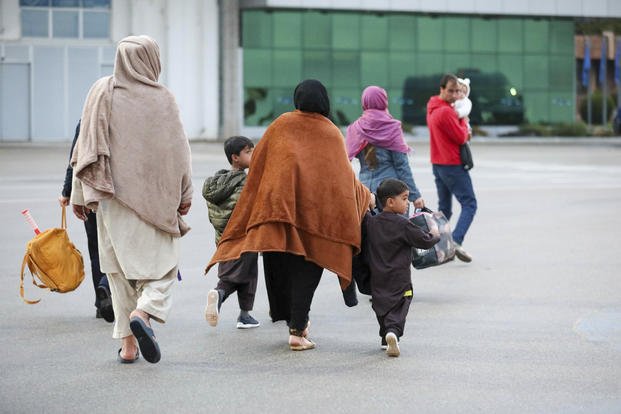 U.S.-affiliated Afghans arrive at the Pristina International Airport in Kosovo.