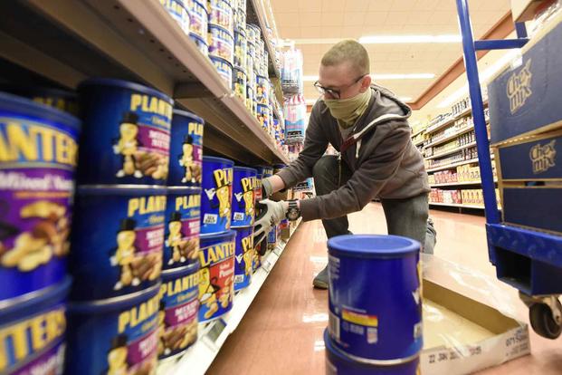 Airman stocks shelves the commissary on Wright-Patterson