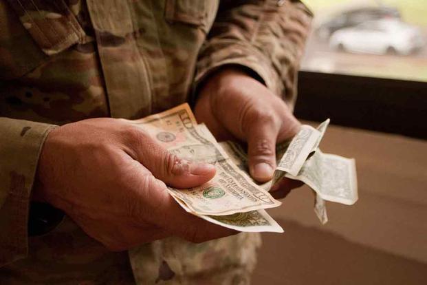 A soldier counts his money