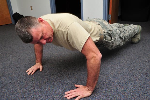 Master sergeant participates in push-up contest.