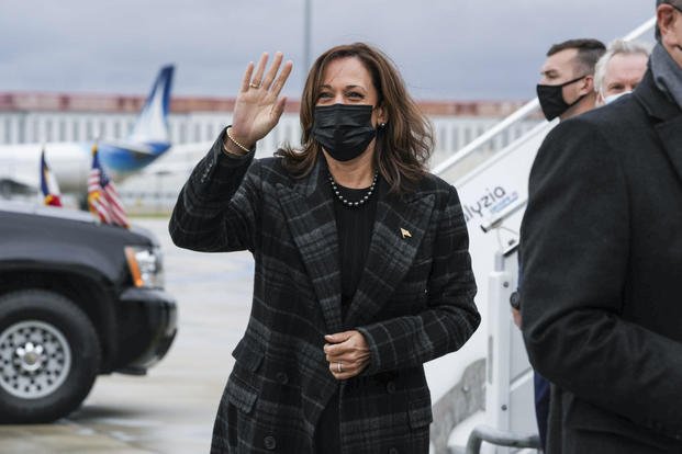 Vice President Kamala Harris waves at Paris-Orly Airport in Orly, France