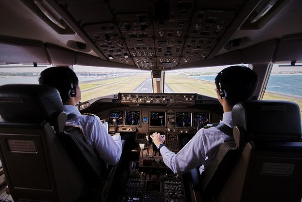 Two Pilots Flying an Airplane Towards the Runway
