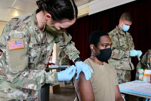 A medic administers a vaccination against COVID-19.