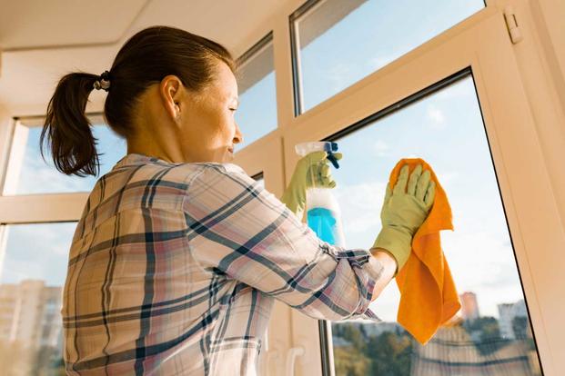 woman cleaning a house window