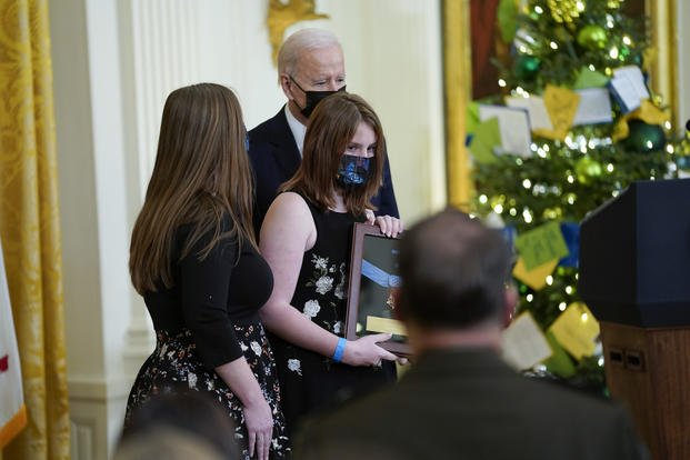 Shannon Celiz, daughter of Sgt. First Class Christopher Celiz, holds Medal of Honor