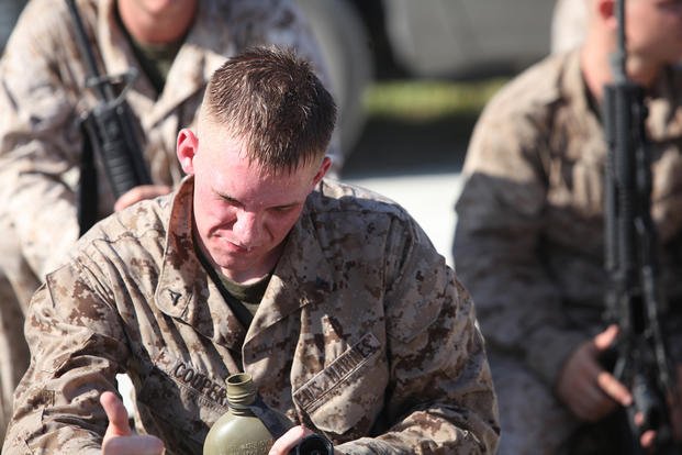 A Marine cools down during a break in his unit's 10-mile forced march held aboard Camp Lejeune, N.C.