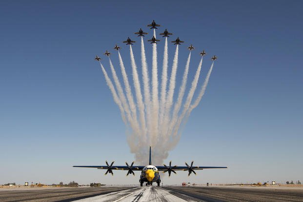 The Navy and Air Force flight demonstration squadrons, the Blue Angels and the Thunderbirds, debut the Super Delta formation over a C-130J Super Hercules at Naval Air Facility El Centro, Calif. 