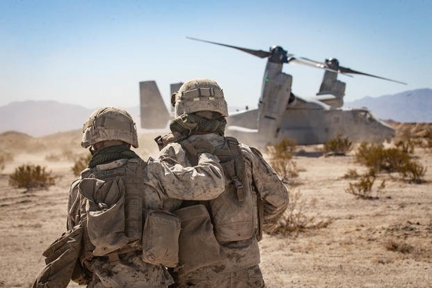 Marines carry simulated casualties to a MV-22 Osprey during motorized operations course