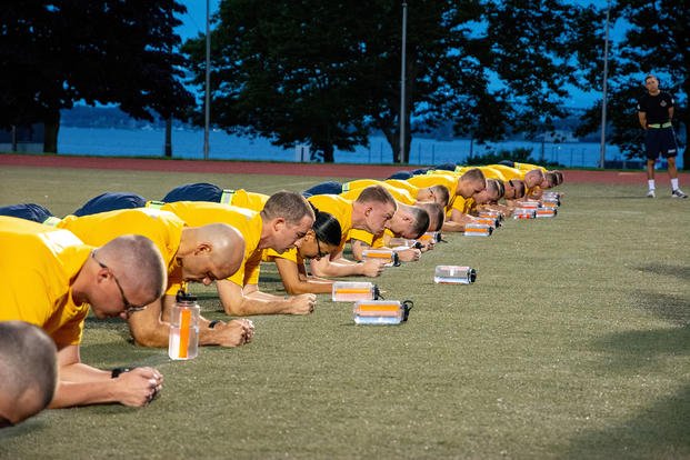 Officer Candidate School students do a low plank as part of a physical fitness assessment.
