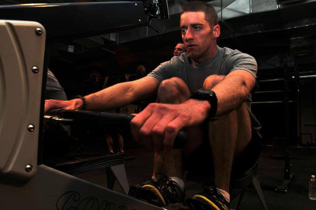 A captain demonstrates rowing exercises during a training routine.