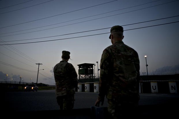 troops stand guard outside Camp Delta at the Guantanamo Bay detention center, in Cuba