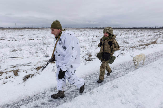 Ukrainian soldiers walk at the line of separation from pro-Russian rebels, Donetsk region