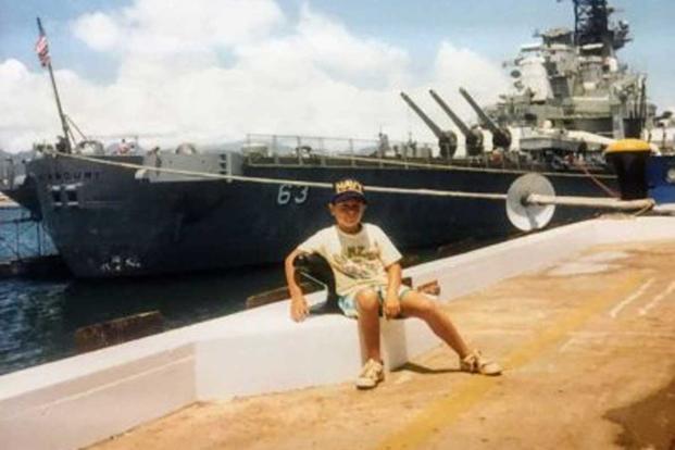 Brian Thompson poses in front of the USS Missouri in Pearl Harbor