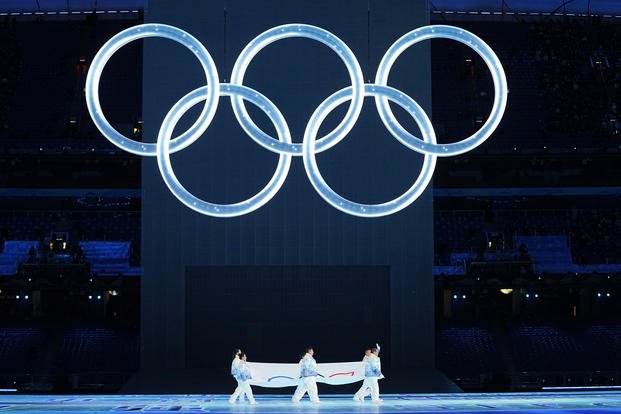 Olympic flag is carried into the stadium during the opening ceremony of the 2022 Winter Olympics