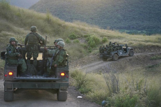 Soldiers patrol near the hamlet Plaza Vieja in the Michoacan state of Mexico.