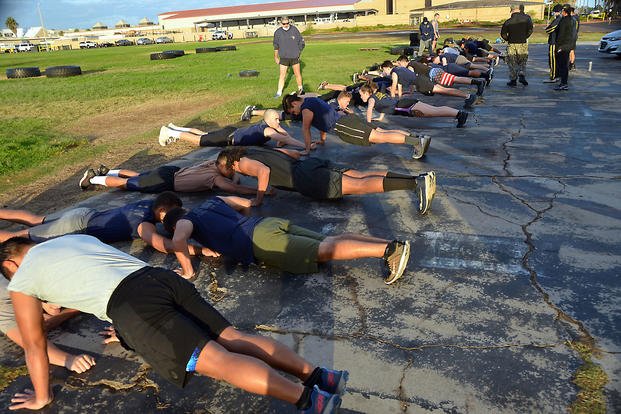 Future sailors try to complete as many push-ups as possible.