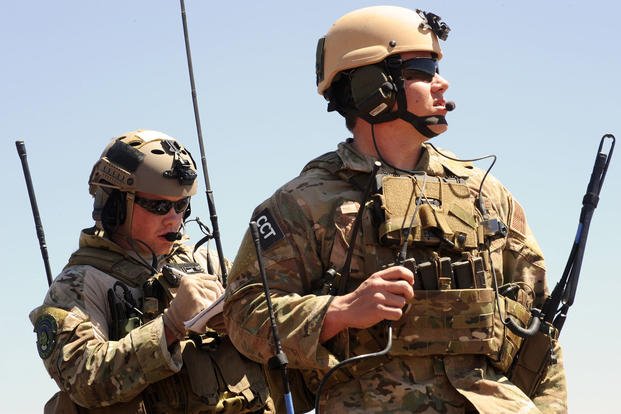 Two Air National Guard combat controllers help conduct airfield landings and takeoffs at Fort Carson.