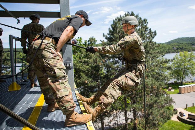 A Sabalauski Air Assault School instructor mentors a West Point cadet during an Air Assault Training tower rappel.